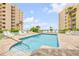 Inviting pool area with lounge chairs, surrounded by well-maintained landscaping and palm trees at 423 S Atlantic Ave # 301, New Smyrna Beach, FL 32169