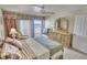 Bedroom featuring neutral decor, generous storage, and sliding glass doors to the private patio at 4435 S Atlantic Ave # 416, Port Orange, FL 32127
