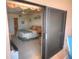 Comfortable bedroom features neutral decor and access to the patio and ensuite bathroom at 4435 S Atlantic Ave # 416, Port Orange, FL 32127