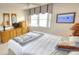 Bright bedroom featuring nautical décor, side tables, and an abundance of drawers and storage at 4435 S Atlantic Ave # 416, Port Orange, FL 32127