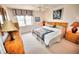 Bright bedroom features a ceiling fan, large window, and quaint, nautical themed décor at 4435 S Atlantic Ave # 416, Port Orange, FL 32127