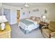 Bedroom features neutral decor, comfortable seating, and access to the ensuite bathroom at 4435 S Atlantic Ave # 416, Port Orange, FL 32127