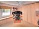 Bright, carpeted home office featuring built in storage, window bench, and desk at 4435 S Atlantic Ave # 416, Port Orange, FL 32127