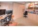 Bright, carpeted home office featuring built in storage, built in desk, and natural light at 4435 S Atlantic Ave # 416, Port Orange, FL 32127