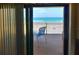 View of the beach from the private patio featuring a chair and unobstructed beach views at 4435 S Atlantic Ave # 416, Port Orange, FL 32127