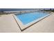 A clean, blue swimming pool surrounded by a tile patio with ocean views at 4435 S Atlantic Ave # 416, Port Orange, FL 32127