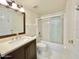 Bathroom with wood vanity and a shower-tub combo with sliding glass doors at 4575 S Atlantic Ave # 6203, Ponce Inlet, FL 32127