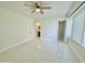Bedroom featuring white tile floors and access to ensuite bath and walk-in closet at 4575 S Atlantic Ave # 6203, Ponce Inlet, FL 32127