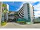 Modern condominium building with multiple floors and balconies surrounded by lush tropical landscaping at 4575 S Atlantic Ave # 6203, Ponce Inlet, FL 32127