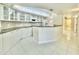 Modern kitchen with white cabinets, granite countertops, and stainless steel appliances at 4575 S Atlantic Ave # 6203, Ponce Inlet, FL 32127