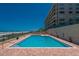 Outdoor pool area with ocean views, lounge chairs, and brick patio at 4575 S Atlantic Ave # 6203, Ponce Inlet, FL 32127