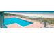 Outdoor pool with lounge chairs on brick patio overlooking beach and ocean at 4575 S Atlantic Ave # 6203, Ponce Inlet, FL 32127