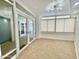 Bright sun room with tile floors, large glass doors, and windows at 4575 S Atlantic Ave # 6203, Ponce Inlet, FL 32127
