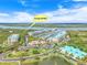 Aerial view of waterfront condo complex with marina, pool, and lush surroundings at 4620 Riverwalk Village Ct # 7403, Ponce Inlet, FL 32127