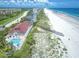 Stunning aerial view of a beachfront property with a pool and private beach access at 4620 Riverwalk Village Ct # 7403, Ponce Inlet, FL 32127