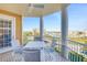 Covered balcony with a table and chairs, offering views of the marina and nearby buildings at 4620 Riverwalk Village Ct # 7403, Ponce Inlet, FL 32127