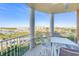 Balcony view showcasing seating, marina, and buildings against a blue sky at 4620 Riverwalk Village Ct # 7403, Ponce Inlet, FL 32127