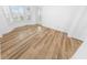 Bright bedroom featuring wood-look floors and large windows with plantation shutters at 4620 Riverwalk Village Ct # 7403, Ponce Inlet, FL 32127