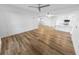 Bright living room with wood floors, ceiling fan, and access to kitchen at 4620 Riverwalk Village Ct # 7403, Ponce Inlet, FL 32127