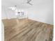 Spacious living room with wood floors, modern lighting, and an open kitchen at 4620 Riverwalk Village Ct # 7403, Ponce Inlet, FL 32127