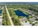 Aerial view of community with water view, lush landscape and surrounding neighborhood at 511 Mount Olympus Blvd, New Smyrna Beach, FL 32168