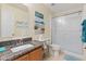 Bathroom with granite countertops, shower, and coastal decor accents at 511 Mount Olympus Blvd, New Smyrna Beach, FL 32168
