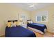 Bright bedroom with two twin beds, decorative pillows, and natural light from the window at 511 Mount Olympus Blvd, New Smyrna Beach, FL 32168