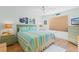 Nautical-themed bedroom features a queen bed with colorful striped bedding and light green nightstands at 511 Mount Olympus Blvd, New Smyrna Beach, FL 32168