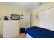 Cozy bedroom featuring a dresser, closet, TV, and decorative accents at 511 Mount Olympus Blvd, New Smyrna Beach, FL 32168