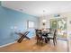 Cozy dining room with a glass table, seating for four, and access to the patio at 511 Mount Olympus Blvd, New Smyrna Beach, FL 32168