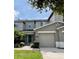 Charming multi-story townhouse showcasing a well-manicured lawn and a two-car garage at 511 Mount Olympus Blvd, New Smyrna Beach, FL 32168
