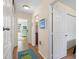 Hallway view with open doorways to a bedroom and bathroom, featuring hardwood flooring at 511 Mount Olympus Blvd, New Smyrna Beach, FL 32168