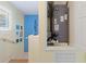 Staircase featuring blue accent wall, white trim, and wood railing with storage for the HVAC system at 511 Mount Olympus Blvd, New Smyrna Beach, FL 32168