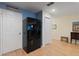Kitchen area featuring black refrigerator and contrasting white doors and trim at 511 Mount Olympus Blvd, New Smyrna Beach, FL 32168