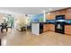 Open-concept kitchen with modern appliances, wood floors and a cozy living space at 511 Mount Olympus Blvd, New Smyrna Beach, FL 32168
