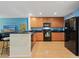 Spacious kitchen with stainless steel appliances, wood cabinets and breakfast bar at 511 Mount Olympus Blvd, New Smyrna Beach, FL 32168