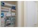 Organized linen closet with shelves and wire baskets, stocked with towels and linens at 511 Mount Olympus Blvd, New Smyrna Beach, FL 32168