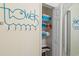Charming linen closet featuring a blue towel rack and neatly arranged shelves at 511 Mount Olympus Blvd, New Smyrna Beach, FL 32168