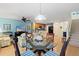 Open living area with a dining table, view of the stairs, and a modern kitchen at 511 Mount Olympus Blvd, New Smyrna Beach, FL 32168