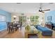 Open-concept living area features a dining table, comfy seating, and a view to the patio at 511 Mount Olympus Blvd, New Smyrna Beach, FL 32168