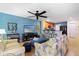 Inviting living room adjacent to the kitchen with a ceiling fan and contemporary decor at 511 Mount Olympus Blvd, New Smyrna Beach, FL 32168