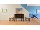 Living room with a dark cabinet, two small stools and beach themed artwork at 511 Mount Olympus Blvd, New Smyrna Beach, FL 32168