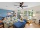 Cozy living area with comfortable seating, a ceiling fan, and view to the dining room at 511 Mount Olympus Blvd, New Smyrna Beach, FL 32168