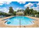 Community pool with plenty of lounging chairs and shaded area for relaxation at 511 Mount Olympus Blvd, New Smyrna Beach, FL 32168