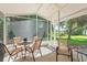 The screened patio has plenty of seating for enjoying the outdoors at 511 Mount Olympus Blvd, New Smyrna Beach, FL 32168