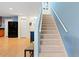 Staircase to the upper level with access to the kitchen and hallway at 511 Mount Olympus Blvd, New Smyrna Beach, FL 32168