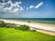 Expansive green backyard leading to a sandy beach with clear blue ocean views at 5201 S Atlantic Ave # 407A, New Smyrna Beach, FL 32169