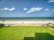 Lush green backyard with direct access to the beach and ocean views at 5201 S Atlantic Ave # 407A, New Smyrna Beach, FL 32169