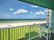 Balcony with ocean views, white railings, and a table, ideal for outdoor enjoyment at 5201 S Atlantic Ave # 407A, New Smyrna Beach, FL 32169