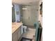 Clean bathroom featuring glass-enclosed shower, toilet, and sink at 5201 S Atlantic Ave # 407A, New Smyrna Beach, FL 32169